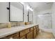 Bathroom boasts dual sinks, a marble countertop, and a shower with glass doors at 18249 W Mauna Loa Ln, Surprise, AZ 85388
