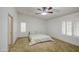 Clean, modern bedroom features a ceiling fan, shutters, and neutral-toned carpet at 18249 W Mauna Loa Ln, Surprise, AZ 85388