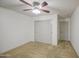 Cozy bedroom featuring a ceiling fan and convenient closet and door placement at 18249 W Mauna Loa Ln, Surprise, AZ 85388