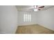 Bright bedroom with a ceiling fan, plush carpet, and plantation shutters on the window at 18249 W Mauna Loa Ln, Surprise, AZ 85388