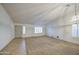 Spacious living room with neutral carpet and bright white walls and natural light at 18249 W Mauna Loa Ln, Surprise, AZ 85388