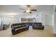Bright living room showcases tile flooring, ceiling fan, and an open floor plan to the kitchen at 18249 W Mauna Loa Ln, Surprise, AZ 85388