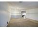 Large living room with neutral carpet, bright white walls, a chandelier, and plenty of natural light at 18249 W Mauna Loa Ln, Surprise, AZ 85388