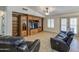 Bright living room featuring comfortable seating, a built-in entertainment center, and access to the outdoors at 18249 W Mauna Loa Ln, Surprise, AZ 85388