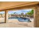View from covered patio overlooking private pool and lush backyard landscaping at 18249 W Mauna Loa Ln, Surprise, AZ 85388