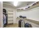 Large walk-in closet with carpet and built in shelving and rods for storage at 18249 W Mauna Loa Ln, Surprise, AZ 85388