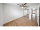 Bright bedroom with wood-look floors, a modern ceiling fan, and a mirrored closet for added convenience at 18811 N 19Th Ave # 2020, Phoenix, AZ 85027