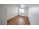 Bright bedroom featuring stylish wood floors, ceiling fan and white walls at 18811 N 19Th Ave # 2020, Phoenix, AZ 85027