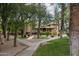 Community outdoor area featuring picnic tables, barbecue grills, and mature trees at 18811 N 19Th Ave # 2020, Phoenix, AZ 85027