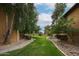 Lush community green space featuring walking path and landscaped ground cover between buildings at 18811 N 19Th Ave # 2020, Phoenix, AZ 85027
