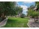 Picturesque community green space with mature trees and landscaping features for relaxation at 18811 N 19Th Ave # 2020, Phoenix, AZ 85027
