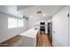 Well-lit kitchen with stainless appliances, island with seating, quartz counters, and modern backsplash at 18811 N 19Th Ave # 2020, Phoenix, AZ 85027
