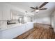 Stylish kitchen featuring white cabinetry, stainless steel appliances, and a center island with marble countertop at 18811 N 19Th Ave # 2020, Phoenix, AZ 85027