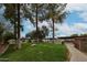 Community green space and parking area with mature trees at 18811 N 19Th Ave # 2020, Phoenix, AZ 85027