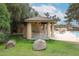 Poolside structure with bar and stools, barbecue and table/chairs in a green common area at 18811 N 19Th Ave # 2020, Phoenix, AZ 85027