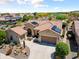Stunning aerial view of the home with a red tile roof, solar panels, desert landscaping, and a three-car garage at 20655 N 273Rd Ave, Buckeye, AZ 85396