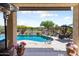 Relaxing covered patio overlooks the crystal blue swimming pool at 20655 N 273Rd Ave, Buckeye, AZ 85396