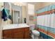 Cozy bathroom featuring a white vanity and patterned shower curtain at 20655 N 273Rd Ave, Buckeye, AZ 85396