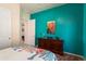 Bright bedroom with cactus-themed decor and turquoise accent wall at 20655 N 273Rd Ave, Buckeye, AZ 85396