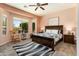 Relaxing primary bedroom with a ceiling fan, rocking chair, and a beautiful view at 20655 N 273Rd Ave, Buckeye, AZ 85396