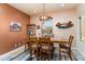This dining area offers a cozy atmosphere with a large window and a beautiful light fixture at 20655 N 273Rd Ave, Buckeye, AZ 85396