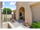 Inviting arched front entryway with desert landscaping and potted flowers, enhancing the home's curb appeal at 20655 N 273Rd Ave, Buckeye, AZ 85396