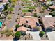 Aerial view of a single Gathering home featuring desert landscaping, solar panels, and a tile roof in a golf course community at 20655 N 273Rd Ave, Buckeye, AZ 85396