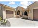 Attractive home with a three-car garage, desert landscaping, and a gated front entry, offering privacy and curb appeal at 20655 N 273Rd Ave, Buckeye, AZ 85396