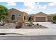 Charming single-story home featuring a desert landscape, tile roof, and attached garage, offering great curb appeal at 20655 N 273Rd Ave, Buckeye, AZ 85396