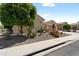 Charming exterior view with drought-tolerant landscaping, red tile roof, and desert plants creating a low-maintenance yard at 20655 N 273Rd Ave, Buckeye, AZ 85396