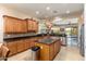 Open kitchen features granite countertops, stainless steel appliances, and a kitchen island with seating at 20655 N 273Rd Ave, Buckeye, AZ 85396