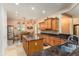 Charming kitchen featuring an island, granite counter tops, a view into the dining area, and decorative lighting at 20655 N 273Rd Ave, Buckeye, AZ 85396