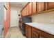 Spacious laundry room with modern washer, dryer, and ample cabinetry at 20655 N 273Rd Ave, Buckeye, AZ 85396