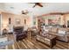 Open living room with leather furniture and bar seating looking into the kitchen at 20655 N 273Rd Ave, Buckeye, AZ 85396