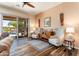 Bright living room with views of the pool and landscaped backyard through sliding glass doors at 20655 N 273Rd Ave, Buckeye, AZ 85396