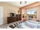 This primary bedroom features a view of the backyard, a fan, and stylish furniture at 20655 N 273Rd Ave, Buckeye, AZ 85396
