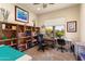 Inviting office space with bookshelves and a window view of desert landscape at 20655 N 273Rd Ave, Buckeye, AZ 85396