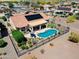 Aerial view of a single Gathering home with a pool, covered patio, desert landscaping, and solar panels at 20655 N 273Rd Ave, Buckeye, AZ 85396