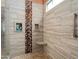 Beautiful shower with unique tile features, a built-in seat, and a handheld shower head at 20655 N 273Rd Ave, Buckeye, AZ 85396