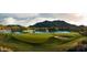 Scenic view of a golf course with a lake, sand trap, and lush green grass at 21612 W Pierson St, Buckeye, AZ 85396