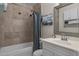 Bathroom featuring tiled shower walls, a vanity with a mirror, and modern fixtures at 225 N Standage -- # 139, Mesa, AZ 85201