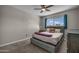 Bedroom featuring neutral walls, carpet, a ceiling fan and a gray bed with a purple throw at 225 N Standage -- # 139, Mesa, AZ 85201