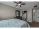 Bedroom featuring neutral walls, carpet, a ceiling fan, closet and a bed with a light green floral comforter at 225 N Standage -- # 139, Mesa, AZ 85201