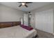Bedroom featuring neutral walls, carpet, and a gray bed with a purple throw, view to bathroom at 225 N Standage -- # 139, Mesa, AZ 85201