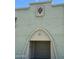 Exterior facade featuring a unique architectural design with a decorative emblem and arched doorway at 225 N Standage -- # 139, Mesa, AZ 85201