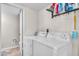 Functional laundry area with washer, dryer, and storage, adjacent to a half bathroom at 225 N Standage -- # 139, Mesa, AZ 85201