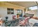 Relaxing covered patio with outdoor furniture and desert plants, ideal for enjoying the outdoors at 225 N Standage -- # 139, Mesa, AZ 85201