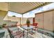 Cozy covered patio with a table, chairs, and plants, offering a peaceful outdoor retreat at 225 N Standage -- # 139, Mesa, AZ 85201