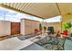 Charming covered patio with outdoor seating, storage shed, and desert landscaping, perfect for relaxation at 225 N Standage -- # 139, Mesa, AZ 85201