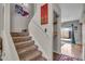 Carpeted staircase with white railing, enhanced by colorful wall art and access to the outdoors at 225 N Standage -- # 139, Mesa, AZ 85201